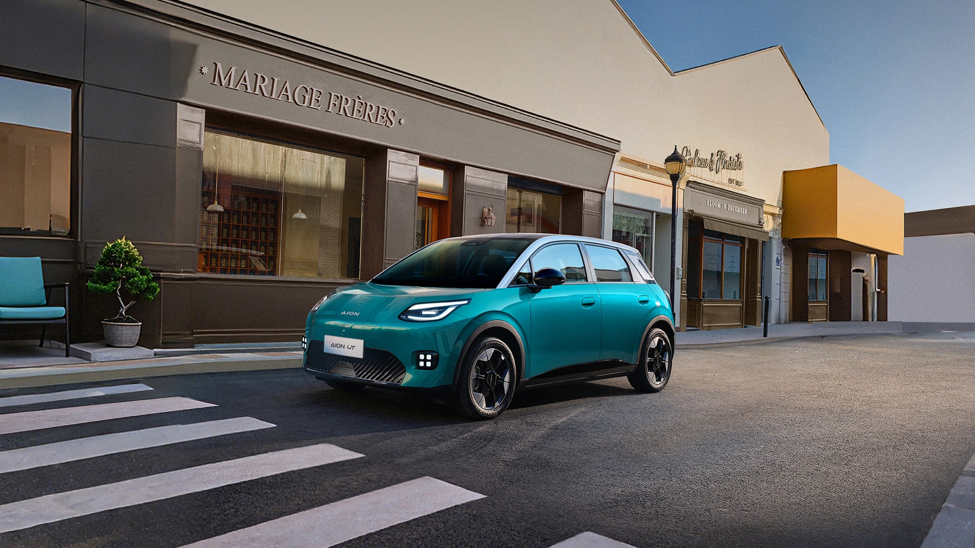 Turquoise AION UT urban mobility scene